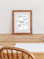 Poster Syhörnan inramad, stående på ett skrivbord.