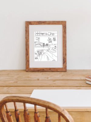 Poster Syhörnan inramad, stående på ett skrivbord.